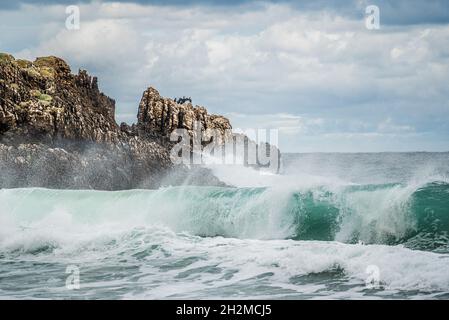 A rock in a choppy swirling sea Stock Photo - Alamy