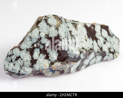 Mineral snow obsidian. The stone is of volcanic origin on a white background. Stock Photo