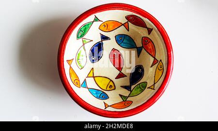 Decorative vintage ceramic bowl with painted fish on white background Stock Photo