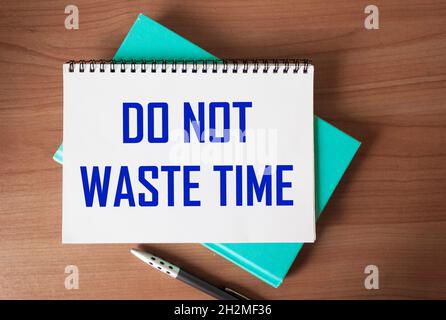 Don't waste time, text words written on notepad, on wooden background, motivational inspirational life and business concept Stock Photo