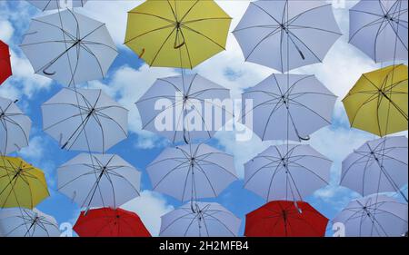 Multicolored street decoration umbrellas on a summer sunny day Stock Photo
