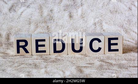 reduce word written on wood block. reduce, reuse and recycle text on wooden table for your desing, concept Stock Photo