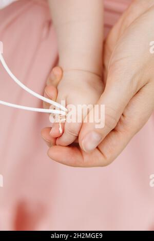 Mother and son praying together. Holding cross in hand. Stock Photo