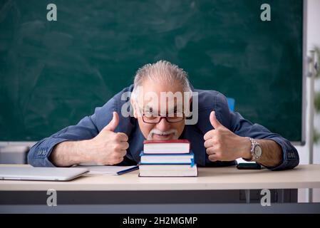 Old teacher in the classroom Stock Photo