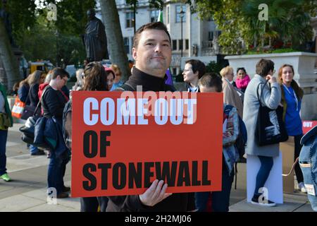 A Demonstrator Holds A Sign During Rally In Opposition To Covid-19 