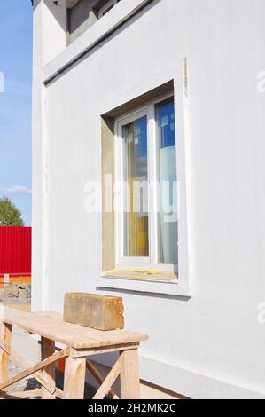 New Installed White Plastic Window with Plastered and Painted New House Wall Stock Photo