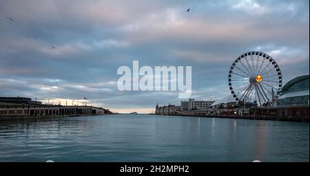 Chicago Navy Pier at sunset. Centennial Wheel and amusement park, calm Michigan lake water, cloudy sky background. Illinois USA Stock Photo