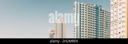 Wall With A Balcony Of New Empty Modern Multi-storey Residential Building House In Residential Area On Blue Sky. Panorama, Panoramic View Stock Photo