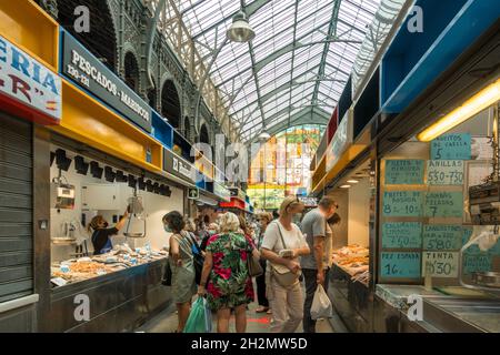Interior of Atarazanas, covered Market with closed vendor kiosks selling seafood in Malaga, Andalusia, Spain.