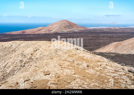 Volcanic landscape with old lava or malpais and volcanoes in Lanzarote, Canary islands, Spain. Stock Photo
