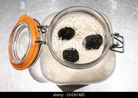 The best way to store truffles: to keep them dry on a bed of rice in a closed glass jar. Stock Photo