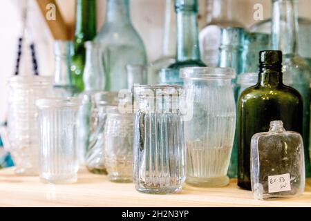 Vintage glass bottles on display at an antique shop (Hampton Court Emporium, East Molesay, UK) Stock Photo