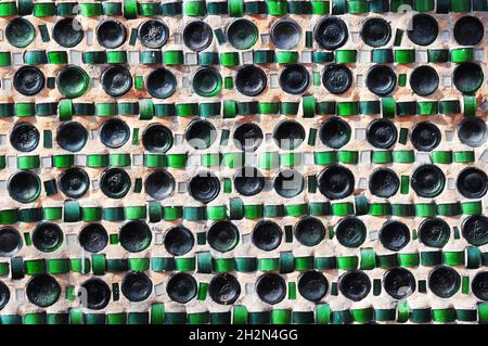 Colorful recycling background texture of empty wine bottles in the wall construction. Stock Photo