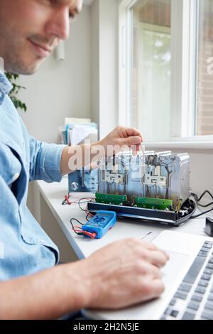 Man Fixing Electric Toaster Using Online Instructions Rather Than Buying New Product Sustainable Lifestyle Stock Photo