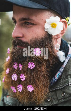 Bearded hipster man wearing flowers Stock Photo