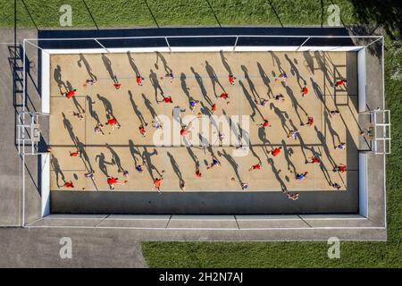 Male and female athletes playing basketball at sports court Stock Photo