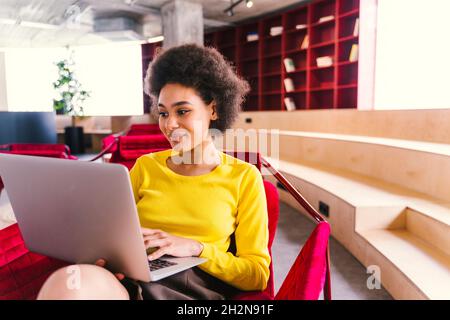 Young businesswoman using laptop in office Stock Photo