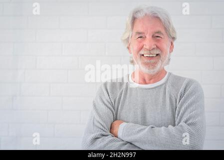 Smiling senior man with arms crossed Stock Photo