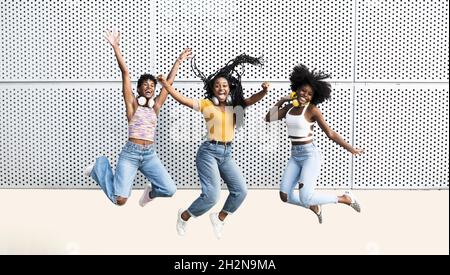 Cheerful woman with arms around female friends Stock Photo