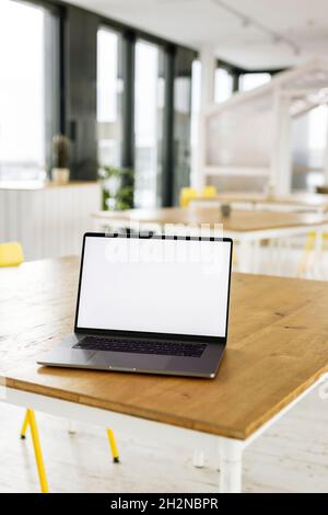 Laptop placed on desk in workplace Stock Photo