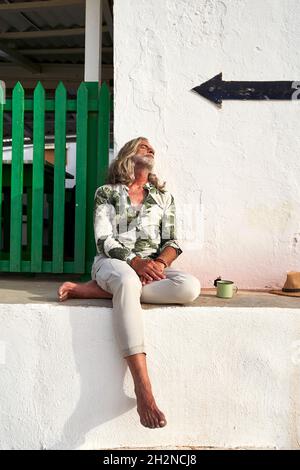 Mature hipster man leaning on wall Stock Photo