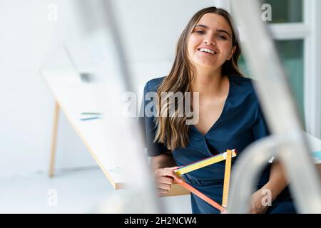 Female architect with folding ruler at workplace Stock Photo