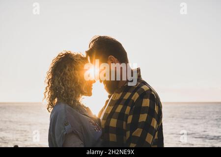 Bearded man romancing with girlfriend at beach Stock Photo