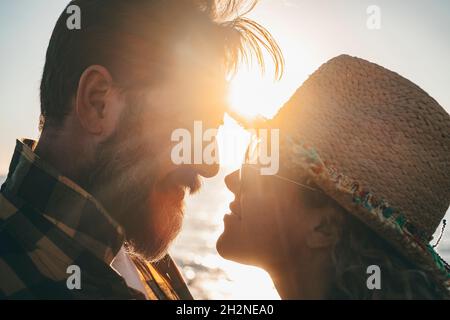 Bearded man romancing with girlfriend during sunset Stock Photo