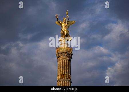 Germany, Berlin, Victory Column standing against cloudy sky Stock Photo