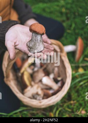 Mid adult woman showing bolete mushroom Stock Photo