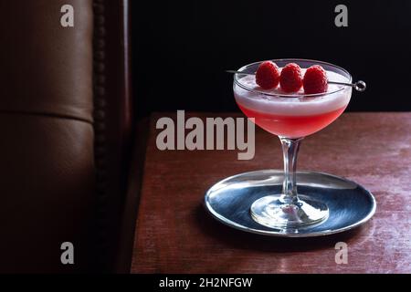 https://l450v.alamy.com/450v/2h2nfgw/clover-club-cocktail-with-raspberries-and-egg-white-foam-in-coupe-glass-in-dark-luxurious-bar-2h2nfgw.jpg