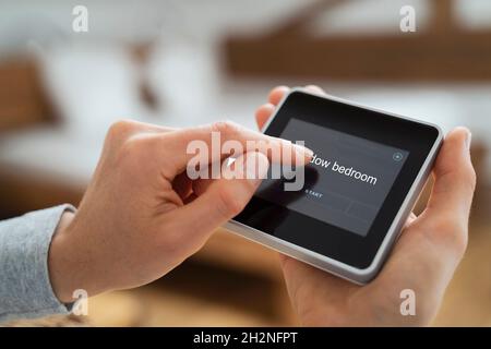 Woman using touch screen smart home device Stock Photo
