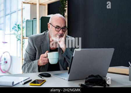 Male professional reading documents in studio Stock Photo