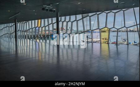 Reykjavik, Iceland – September 22, 2021:  The city’s harbor as seen through the windows of Harpa Stock Photo