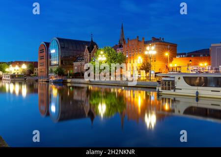 Panorama of Old town with reflection in Brda River at night, Bydgoszcz, Poland Stock Photo