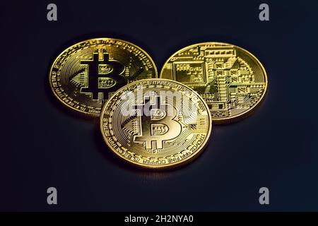 Golden bitcoin coins (BTC) on dark background top view. Virtual money and digital crypto currency concept. Stock Photo