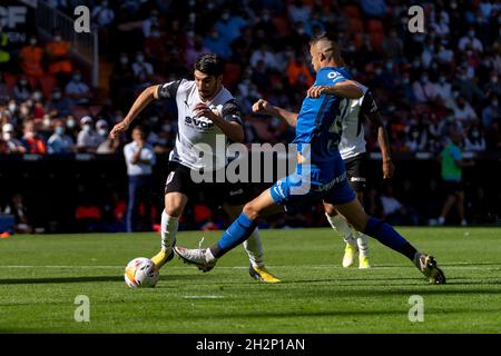 Valencia, Spain. 23rd Oct, 2021. Carlos Soler of Valencia CF and Martin Valjent of RCD Mallorca are seen in action during the Spanish La Liga, football match between Valencia CF and RCD Mallorca at Mestalla stadium in Valencia.(Final score; Valencia CF 2:2 RCD Mallorca) Credit: SOPA Images Limited/Alamy Live News Stock Photo