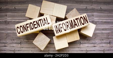 the text of the Confidential Information is written on the web blocks and on a brown background. Top secret Stock Photo