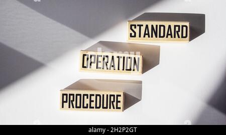 Text sign showing standard operating procedure, text written on wood blocks. Conceptual photo Detailed instructions on how to complete the routine wor Stock Photo