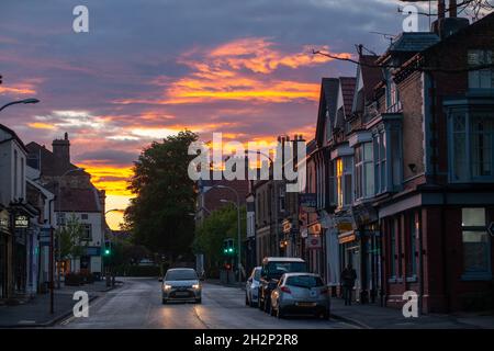 Local shops on Boston Spa High Street, in West Yorkshire at sunset Stock Photo