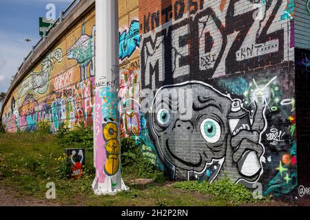 Colourful graffiti / street art next to the River Aire riverside path in Leeds, West Yorkshire Stock Photo