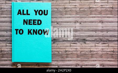 Everything you need to know concepts written on green notepad and wooden table. Stock Photo