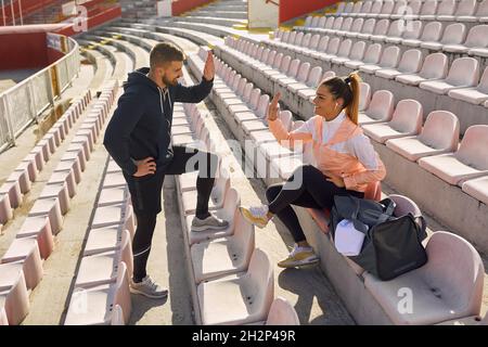 Sporty friends hanging out casually together after training Stock Photo