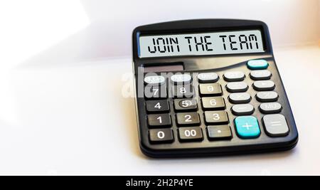Join our team, the text is written on the display of the calculator. Business concept Stock Photo