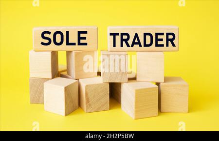 Sole trader on wooden blocks and yellow background. Business concept Stock Photo