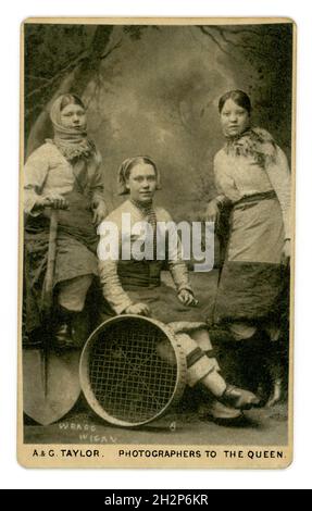 Original Victorian CDV of 3 Wigan (Lancashire) pit brow girls, wearing working clothes, including trousers with shovels and sieves, working tools. Photo by Herbert  Wragg of Wigan (printed on front of photograph)  & reproduced by A. & G. Taylor, 34 Church St. Liverpool, U.K. circa 1885 Stock Photo