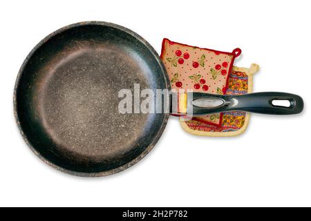 Old used well-loved vintage frying pan with retro potholders, isolated on white background.. Top view from above. Stock Photo