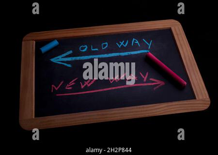 Old way or new way written on chalkboard - black background Stock Photo