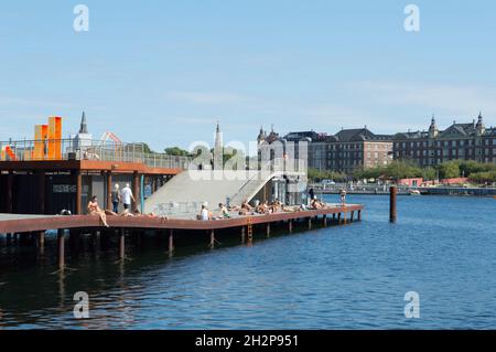 Copenhagen, Denmark - 02 Sep 2021: Young people sunbathing in the city centre, at Kalvebod Wave, Kalvebod Brygge Stock Photo