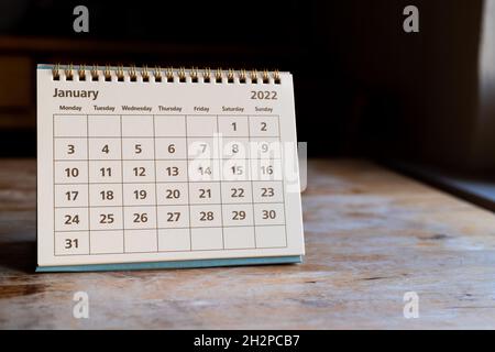 Month page: January in 2022 paper calendar on the wooden table Stock Photo